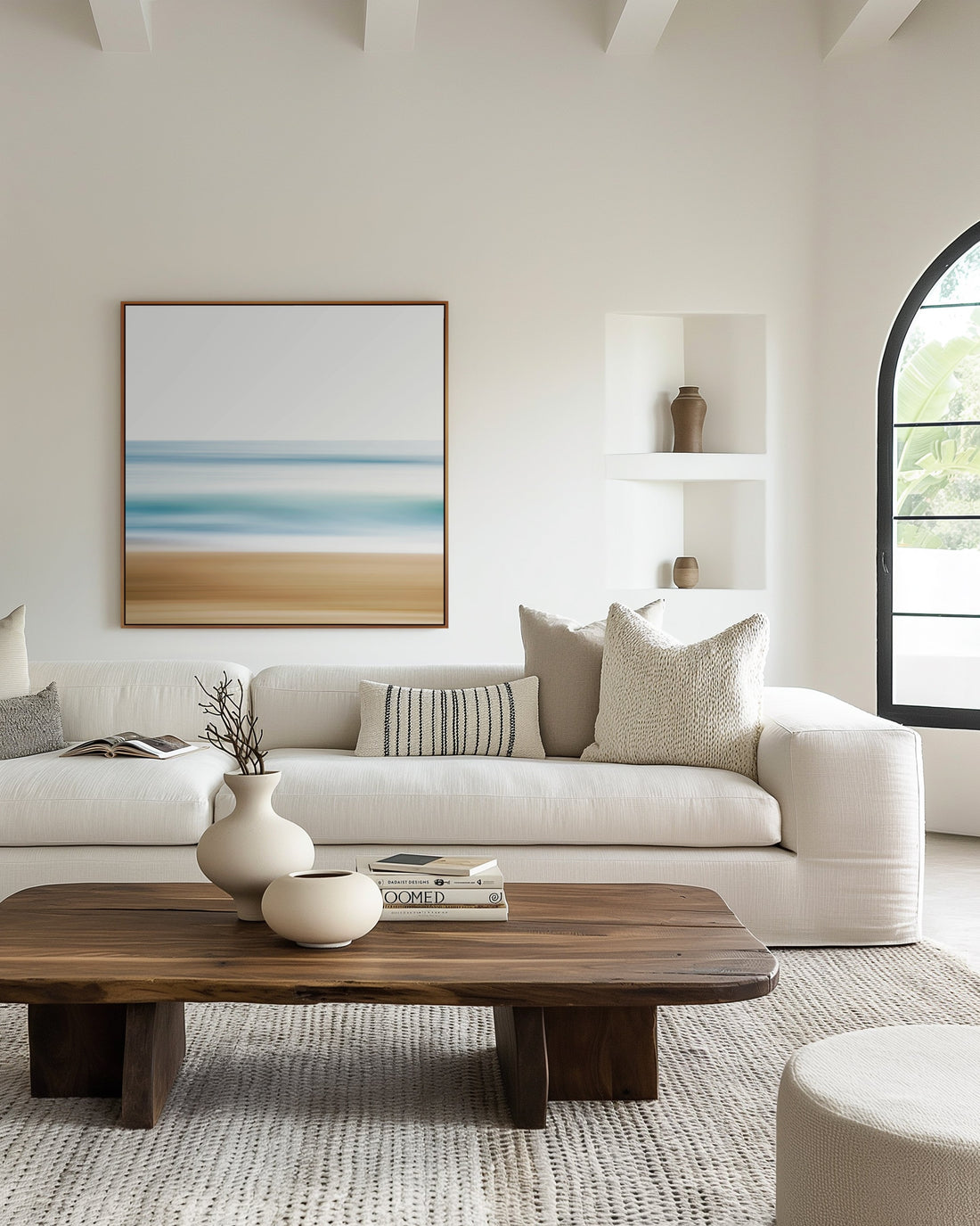 Large coastal canvas print displayed above a white linen sofa in a bright living room — CoastalArtMarket